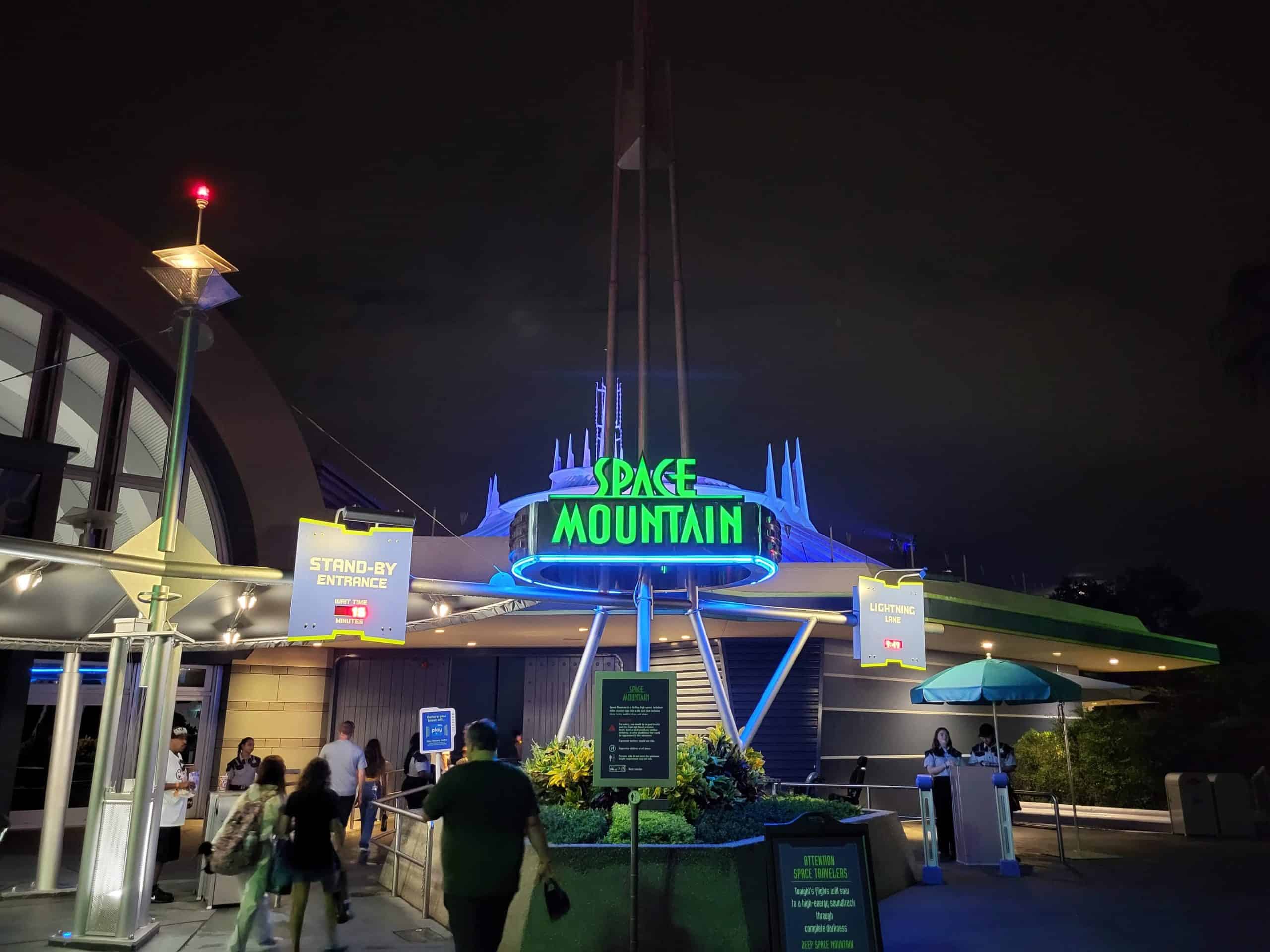 Space Mountain queue entrance sign lit up at night