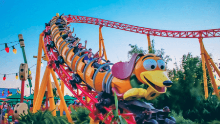 Group of people riding Slinky Dog Dash coming downhill toward the camera.