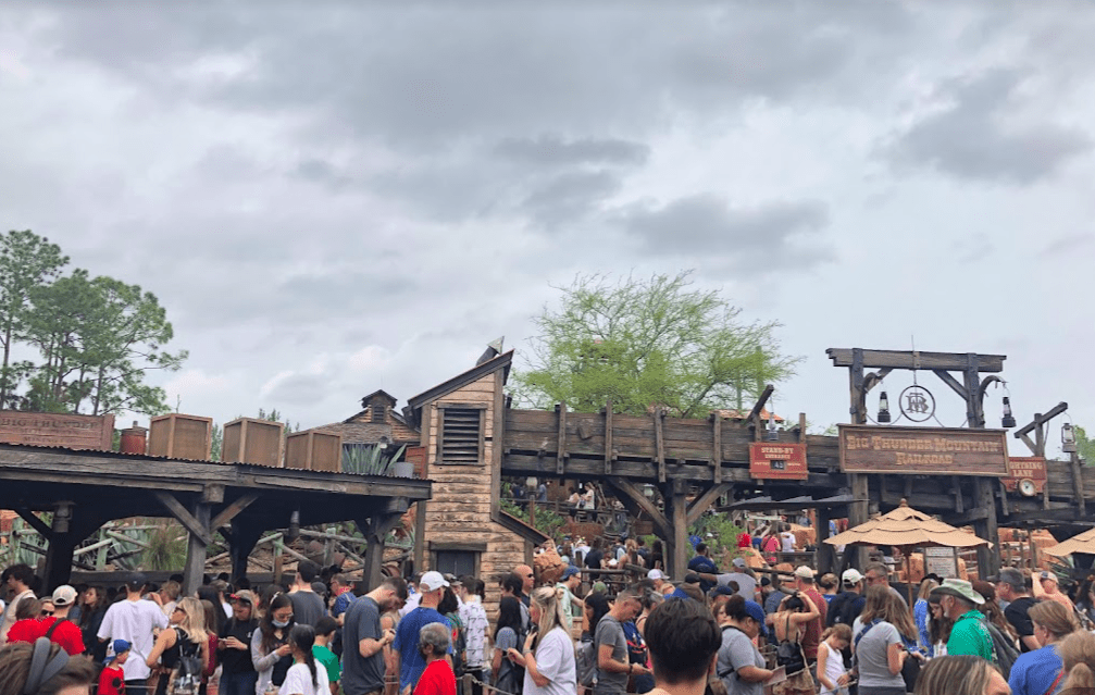 Crowded overflow queue to Big Thunder Mountain at Magic Kingdom on a cloudy day.