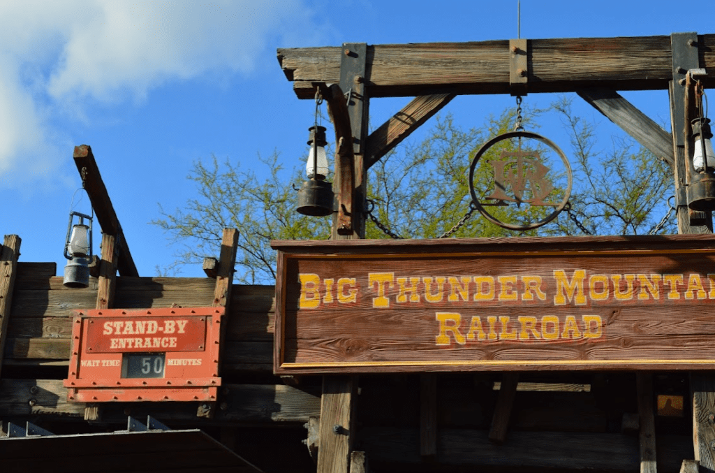 Entrance sign and standby queue reading "Wait Time 50 Minutes" for Big Thunder Mountain Railroad at Magic Kingdom in Disney World.