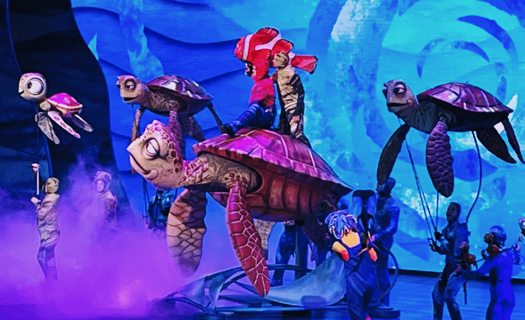 Scene from Finding Nemo show at Walt Disney World featuring a larger-than-life Crush the sea-turtle and other turtle puppets.