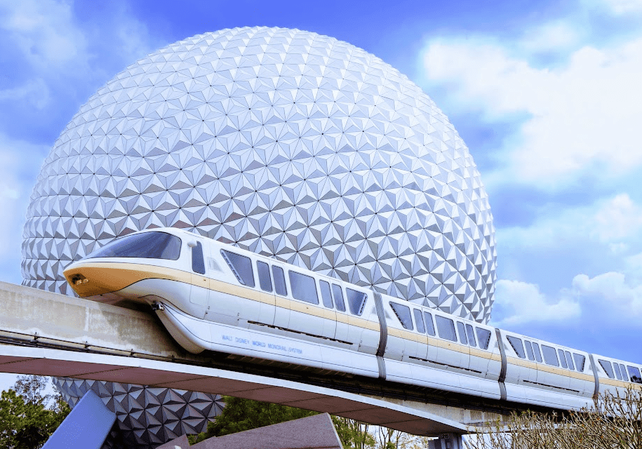 Monorail on the track with background of Spaceship Earth in EPCOT at Walt Disney World.