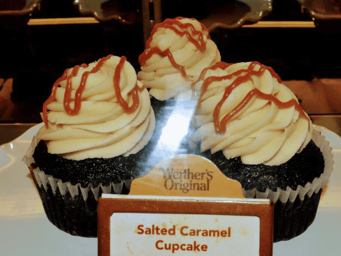 Chocolate cupcake with salted caramel drizzle and icing on top.