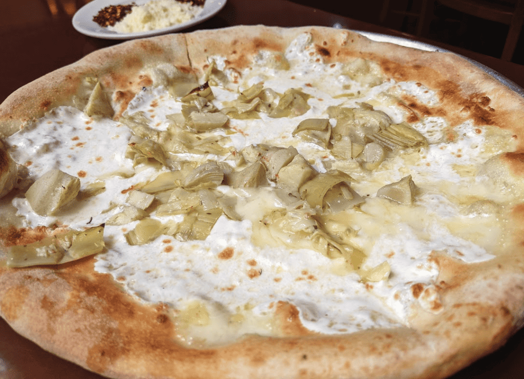 Pizza topped with mozzarella cheese and artichokes.