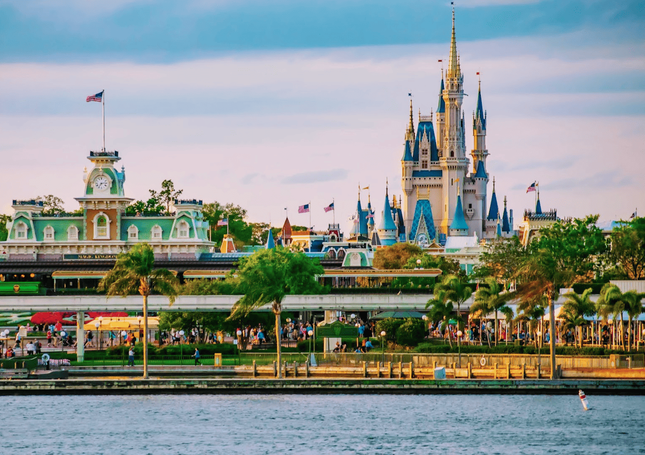 View of Magic Kingdom entrance and Cinderella Castle with water in the foreground.