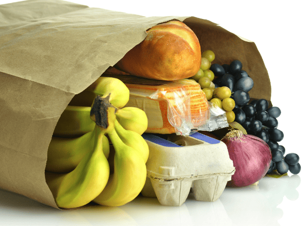 A brown paper bag with groceries (fruits, eggs, bread) in it.