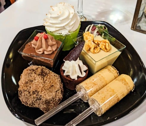 A plate full of desserts from a Magic Kingdom Dessert Party at Walt Disney World.