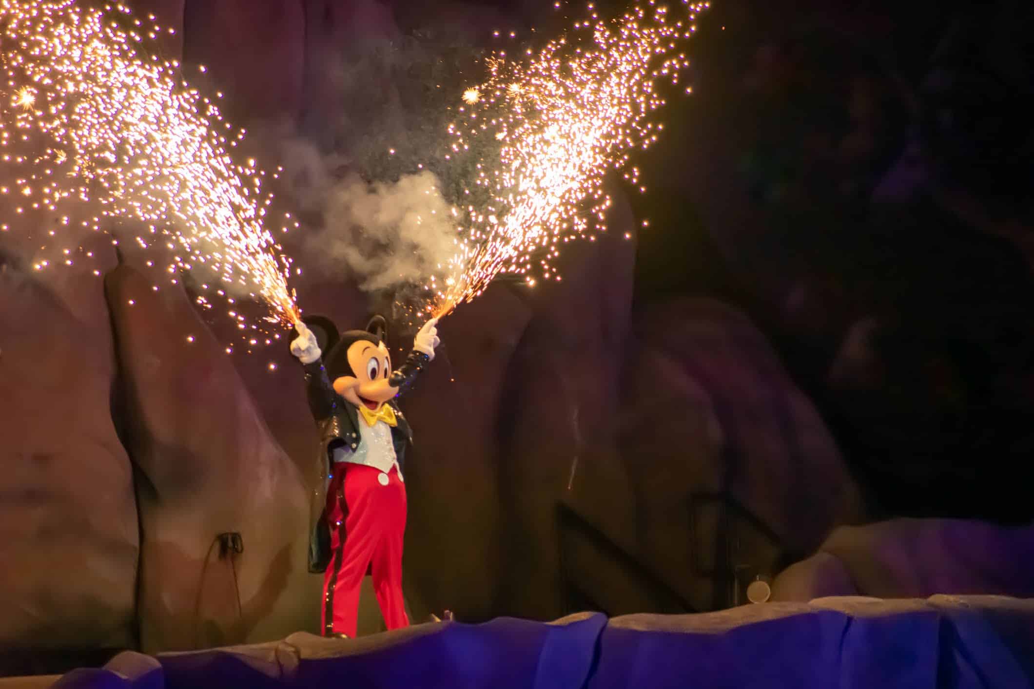 Picture of Mickey Mouse in classic outfit with fireworks shooting out of fingers at the Fantasmic show at Hollywood Studios