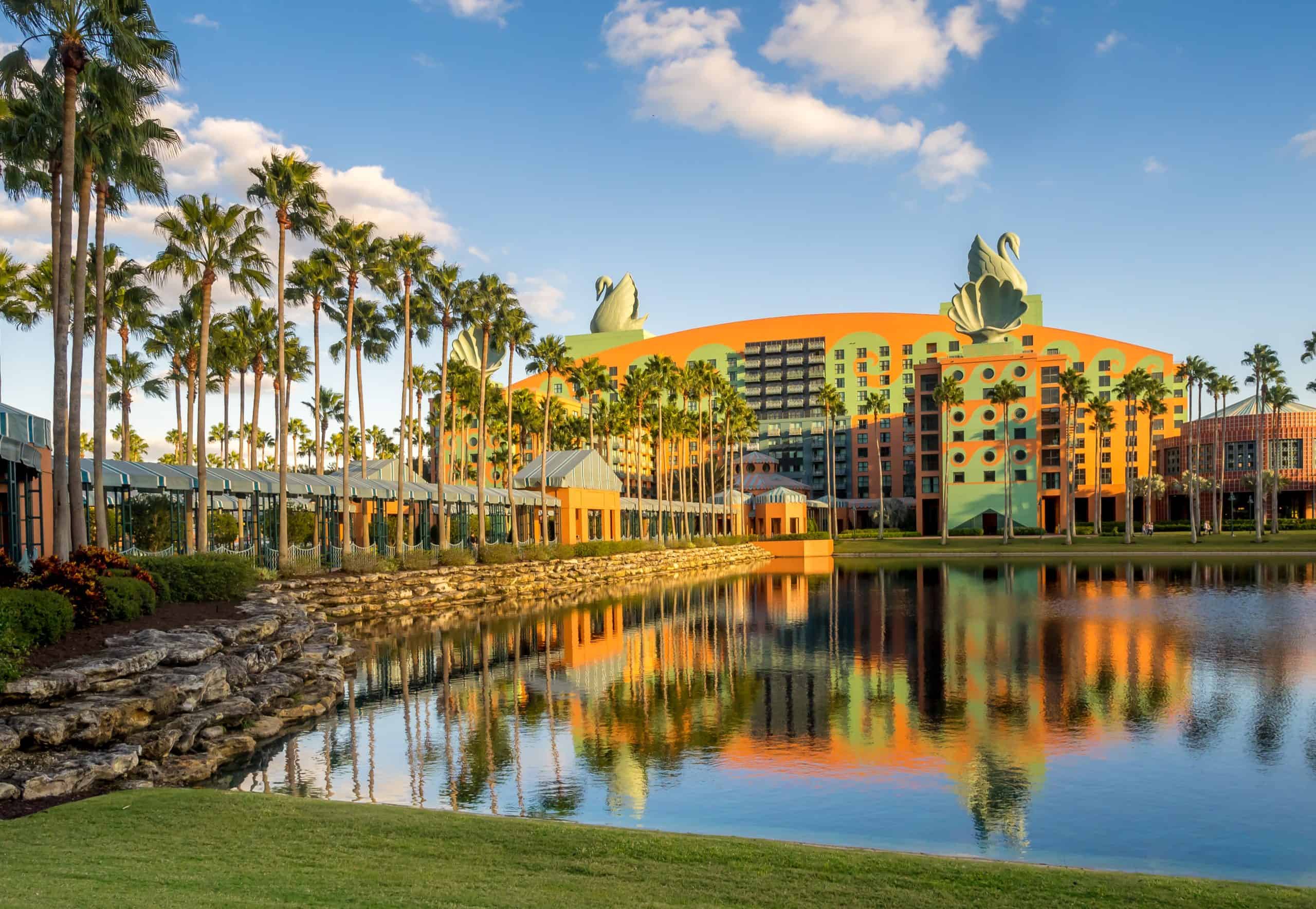 Photo of Swan and Dolphin hotel building with palm trees and sunny day as backdrop
