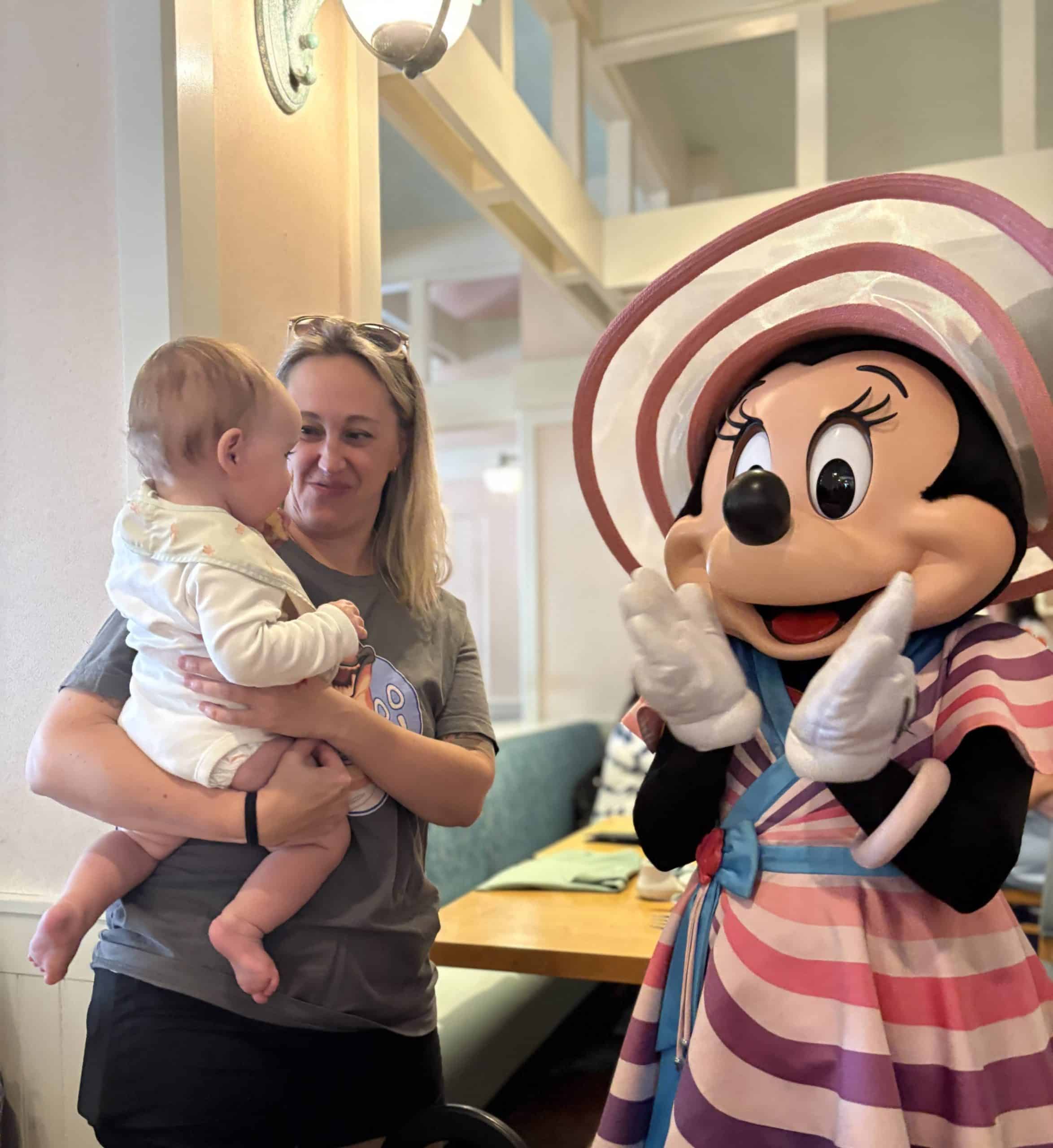 Mom and baby meeting Minnie at Cape May Cafe at Beach Club Disney World