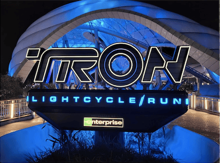 Illuminated sign of TRON Lightcycle Run in front of queue