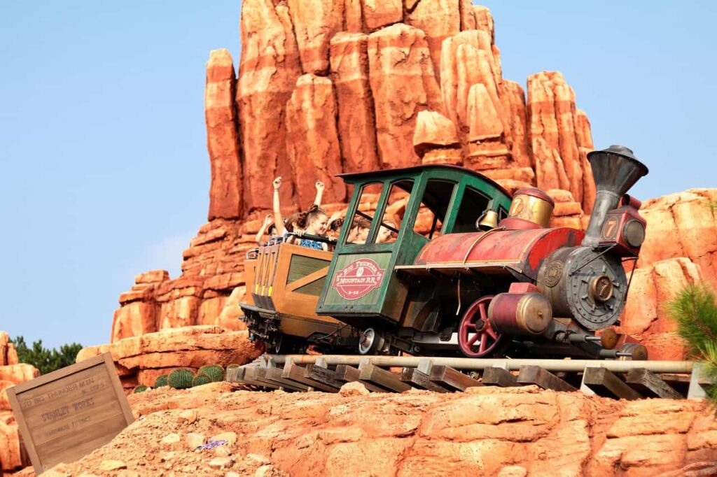 People riding Big Thunder Mountain Railroad on a sunny day at Disneyland