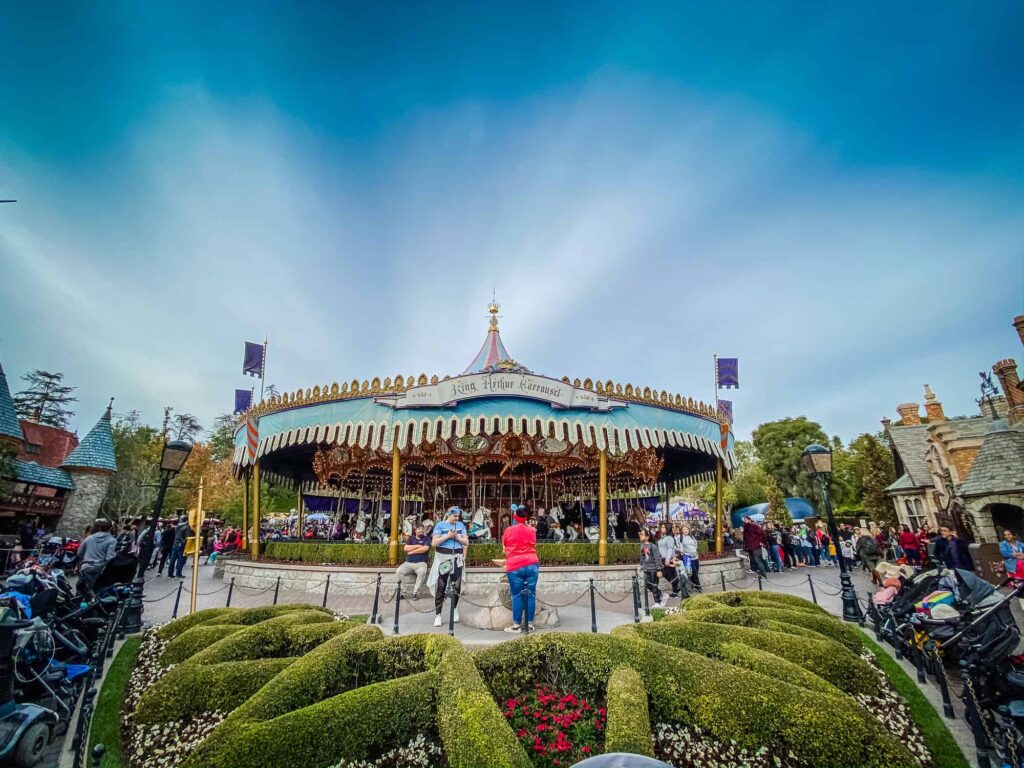 King Arthur Carrousel at Disneyland with blue sky and glare in background