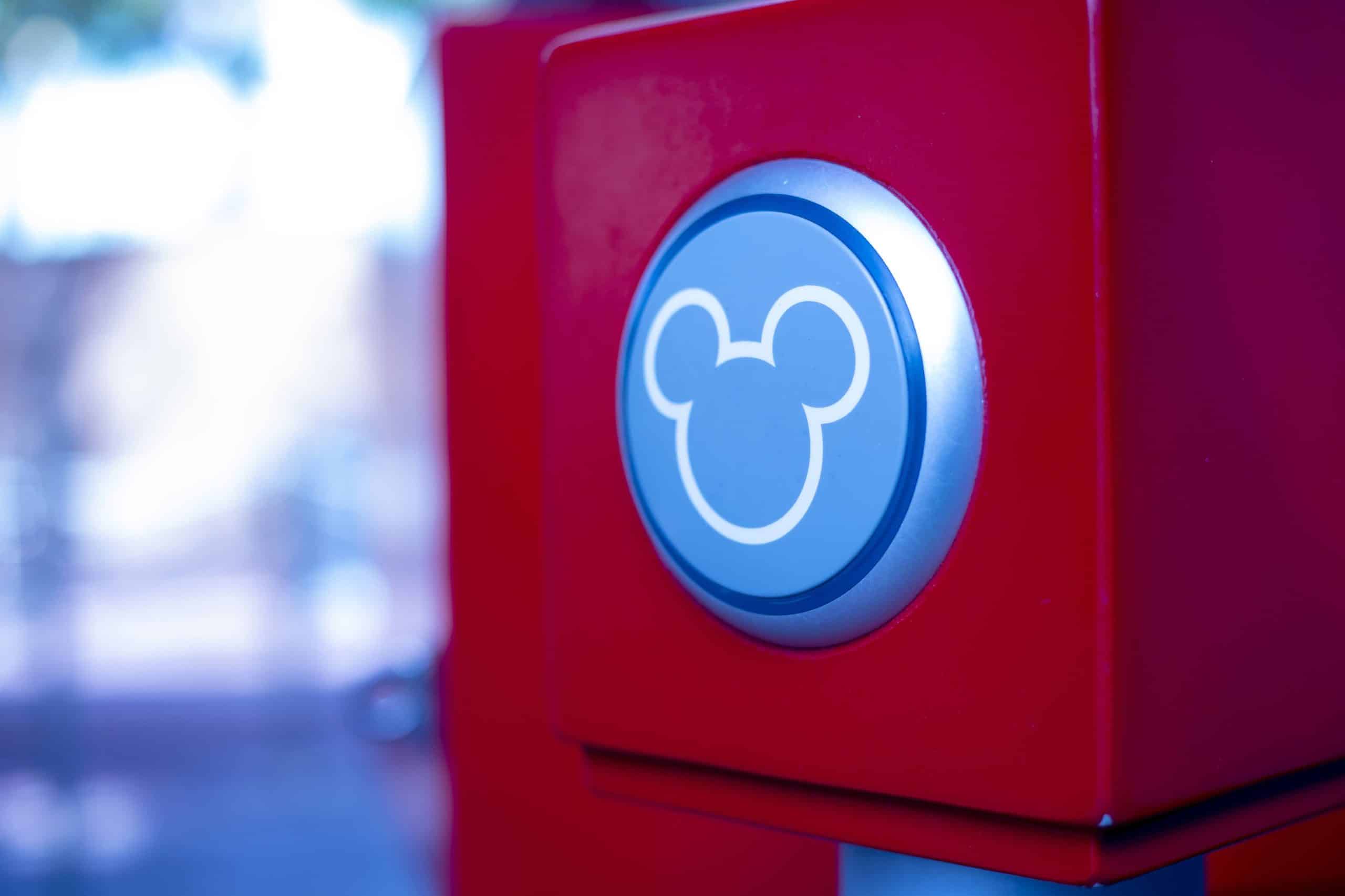 Red turnstile scanner with Mickey Mouse outline on it