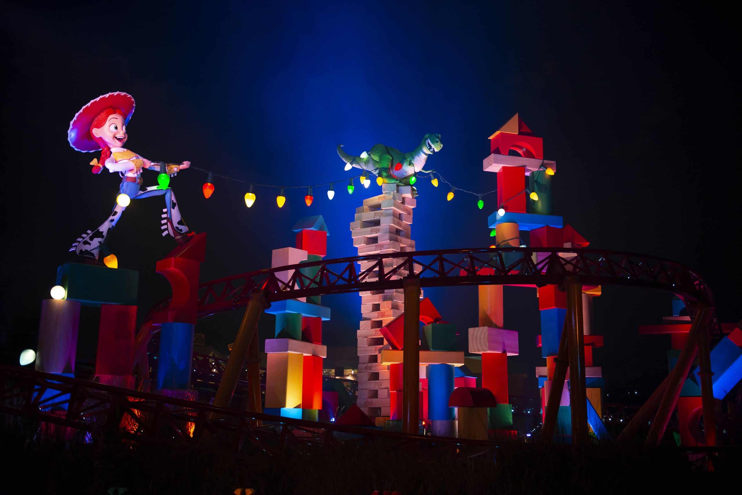 Slinky Dog Dash lit up at night with Rex and characters at Hollywood Studios
